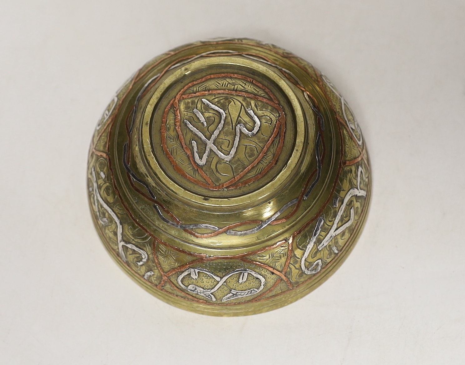 A pair and another inlaid brass dishes, Cairo ware, largest 19cm
